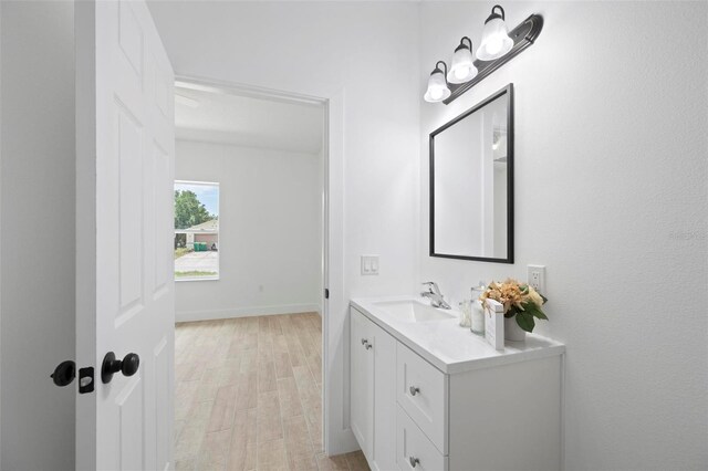 21480 Eldred Ave, Port Charlotte, FL 33952 - bathroom with vanity, wood finished floors, and baseboards