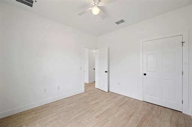 21480 Eldred Ave, Port Charlotte, FL 33952 - unfurnished bedroom with light wood-style floors, baseboards, and a ceiling fan