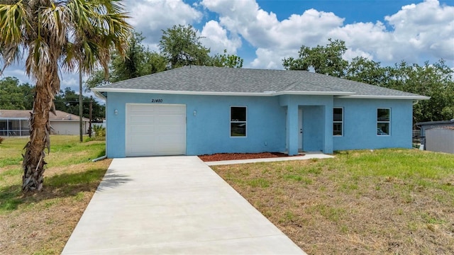 21480 Eldred Ave, Port Charlotte, FL 33952 - single story home with stucco siding, a garage, roof with shingles, and concrete driveway