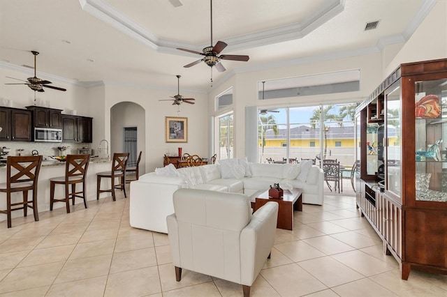 18652 Ohara Dr, Port Charlotte, FL 33948 - living area featuring arched walkways, a ceiling fan, visible vents, and light tile patterned floors