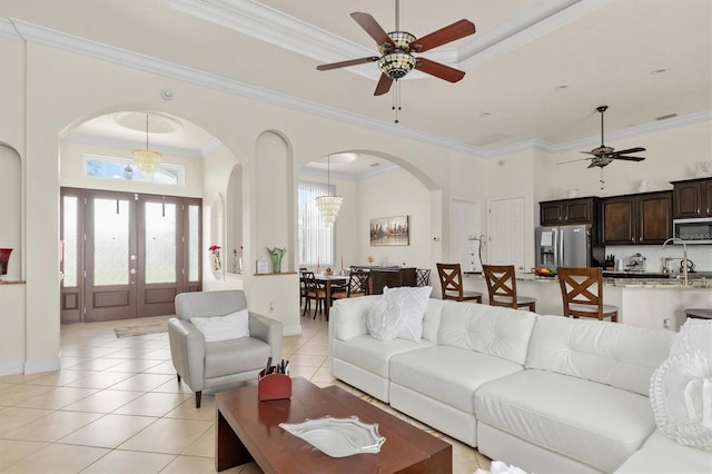 18652 Ohara Dr, Port Charlotte, FL 33948 - living room with ceiling fan with notable chandelier, arched walkways, and ornamental molding