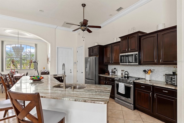 18652 Ohara Dr, Port Charlotte, FL 33948 - kitchen featuring a kitchen breakfast bar, stainless steel appliances, visible vents, a sink, and light tile patterned flooring