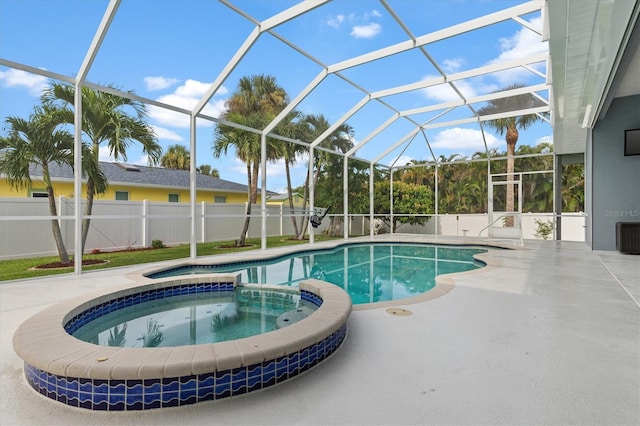 18652 Ohara Dr, Port Charlotte, FL 33948 - view of pool featuring glass enclosure, a pool with connected hot tub, a patio, and fence