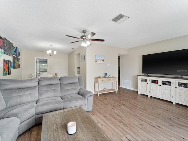 6531 Marius Rd, North Port, FL 34287 - living area featuring baseboards, ceiling fan with notable chandelier, wood finished floors, and visible vents