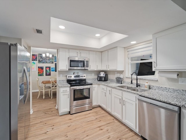 6531 Marius Rd, North Port, FL 34287 - kitchen featuring appliances with stainless steel finishes, a sink, recessed lighting, a tray ceiling, and visible vents