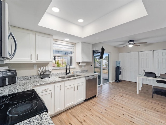 6531 Marius Rd, North Port, FL 34287 - kitchen with a sink, white cabinets, dishwasher, and a healthy amount of sunlight