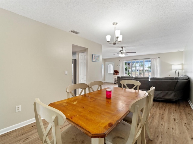 6531 Marius Rd, North Port, FL 34287 - dining area with baseboards, light wood finished floors, a textured ceiling, and visible vents