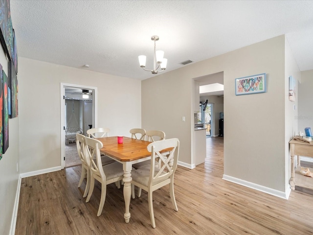 6531 Marius Rd, North Port, FL 34287 - dining space with an inviting chandelier, light wood finished floors, baseboards, and visible vents