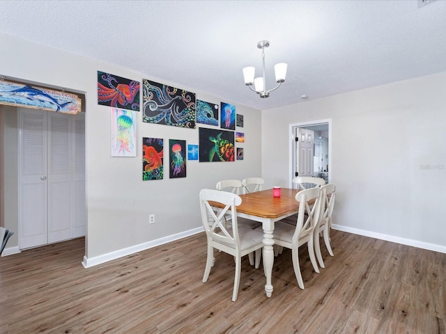 6531 Marius Rd, North Port, FL 34287 - dining space with an inviting chandelier, baseboards, and wood finished floors