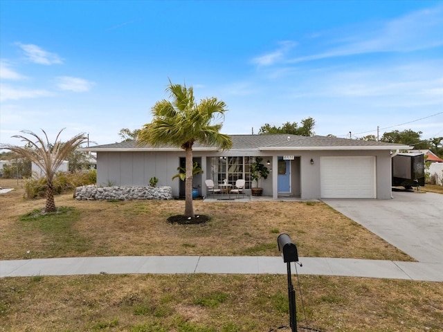 6531 Marius Rd, North Port, FL 34287 - single story home with concrete driveway, a front lawn, and a garage