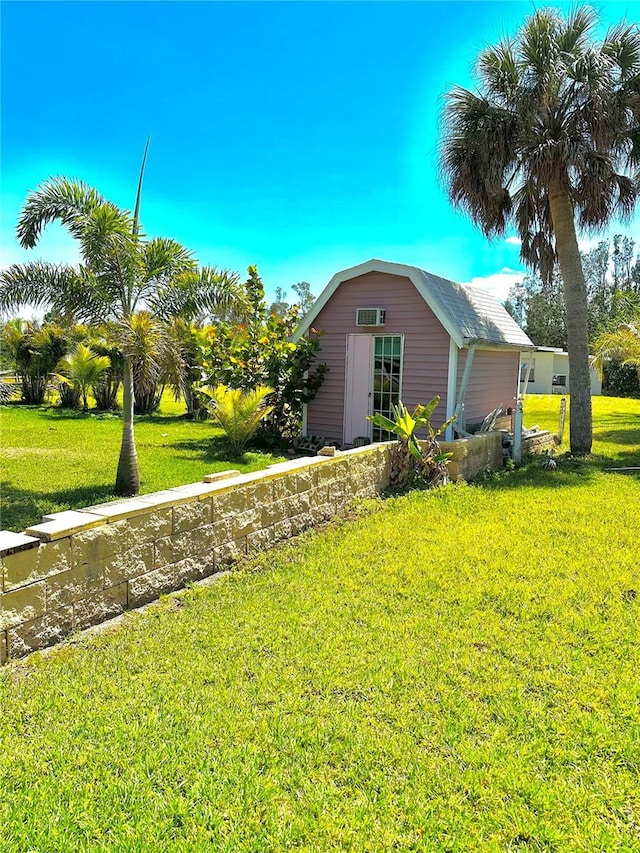 view of side of home featuring a yard, a shed, and an outbuilding