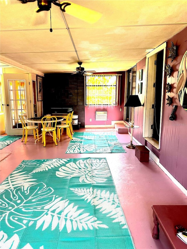 interior space featuring a ceiling fan, a wall mounted AC, and outdoor dining area