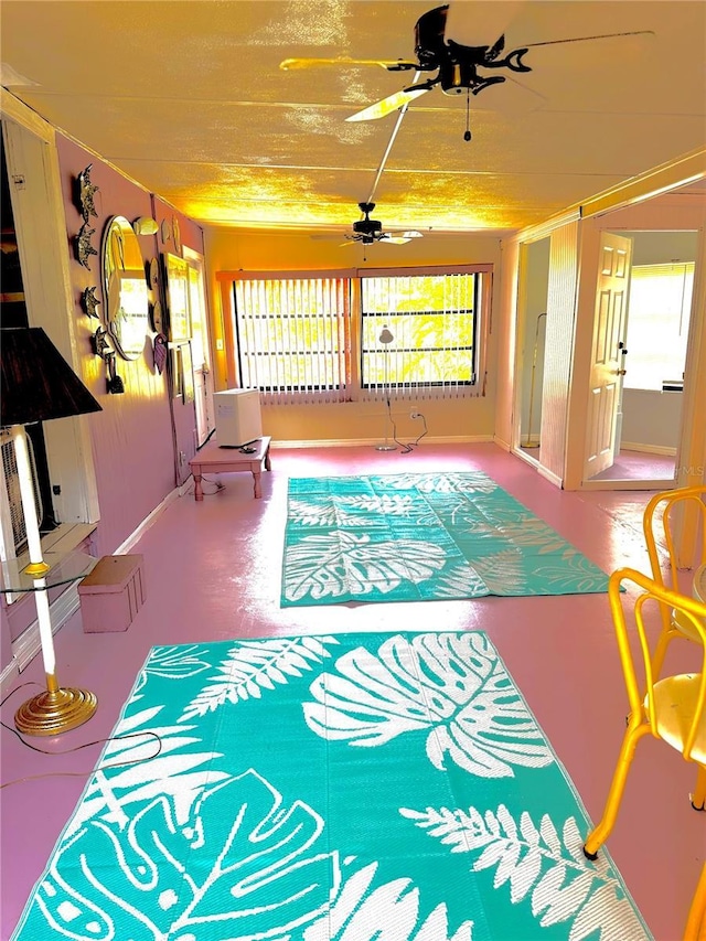 living room with finished concrete floors and a ceiling fan