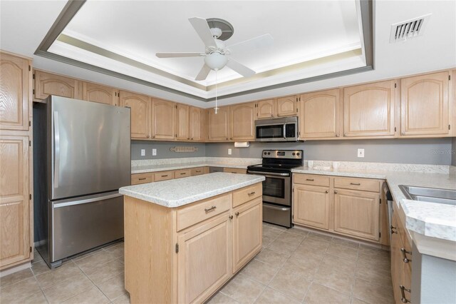 1750 Jamaica Way Unit 312, Punta Gorda, FL 33950 - kitchen featuring light brown cabinetry, a tray ceiling, light countertops, visible vents, and appliances with stainless steel finishes