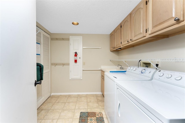 1750 Jamaica Way Unit 312, Punta Gorda, FL 33950 - laundry room with a sink, a textured ceiling, baseboards, cabinet space, and washer and dryer