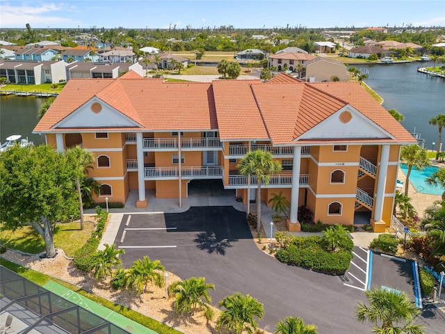birds eye view of property with a water view and a residential view