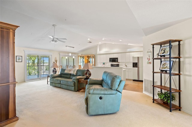 living room featuring visible vents, ceiling fan, lofted ceiling, and light carpet