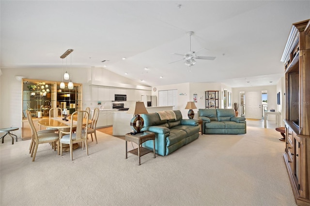 living area featuring light colored carpet, a ceiling fan, and lofted ceiling