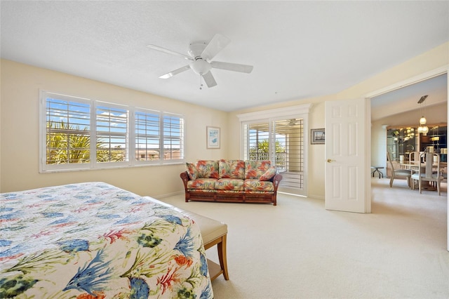 carpeted bedroom featuring baseboards and ceiling fan