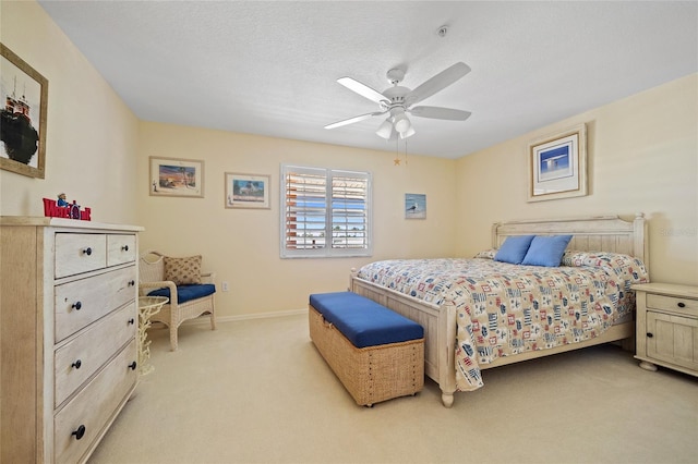 bedroom with a ceiling fan, baseboards, and light colored carpet
