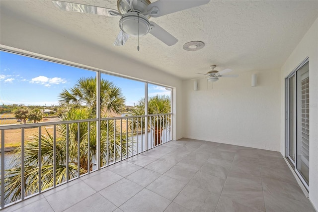 unfurnished sunroom featuring a textured ceiling and tile patterned flooring