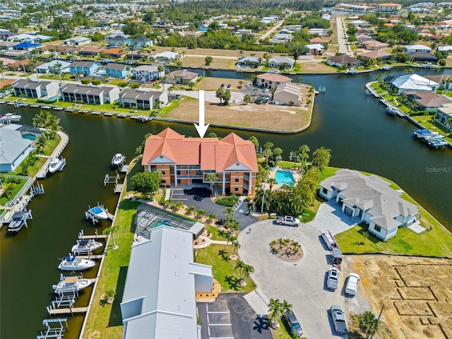birds eye view of property with a water view and a residential view