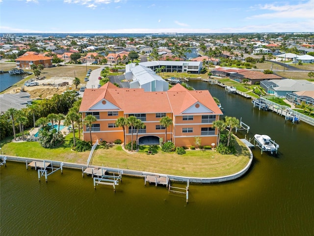 birds eye view of property with a water view and a residential view
