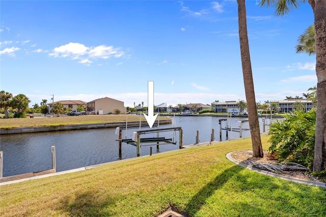 dock area with a residential view, boat lift, a water view, and a lawn
