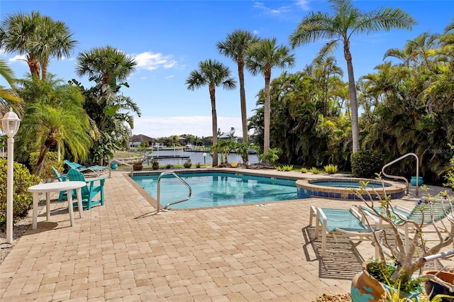 view of pool with a patio and a pool with connected hot tub