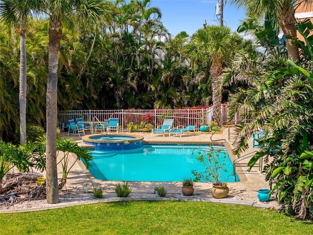 view of swimming pool featuring a patio, an in ground hot tub, fence, and a fenced in pool