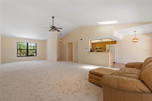 453 Carolyn Ln, Punta Gorda, FL 33950 - living area with ceiling fan with notable chandelier, vaulted ceiling with skylight, and light carpet