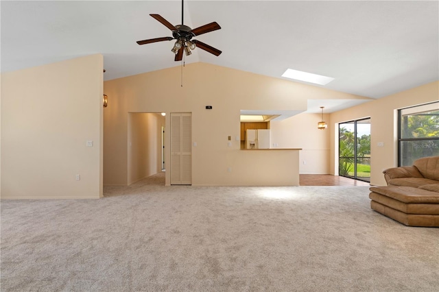 453 Carolyn Ln, Punta Gorda, FL 33950 - carpeted living area with baseboards, ceiling fan, and lofted ceiling with skylight