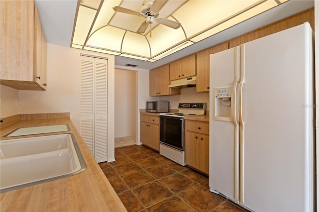 453 Carolyn Ln, Punta Gorda, FL 33950 - kitchen with light countertops, stainless steel microwave, under cabinet range hood, electric stove, and white fridge with ice dispenser