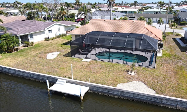 exterior space featuring a tile roof, a patio area, an outdoor pool, a water view, and a residential view