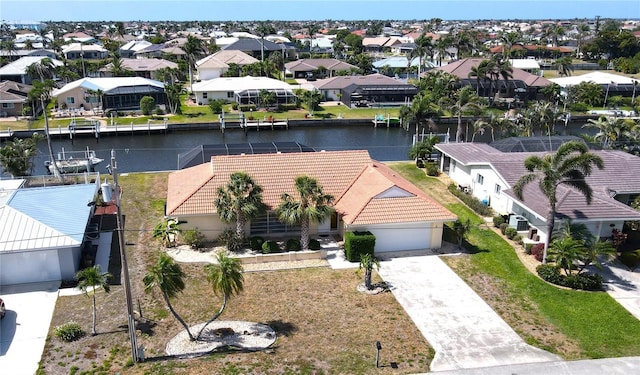 bird's eye view with a residential view and a water view