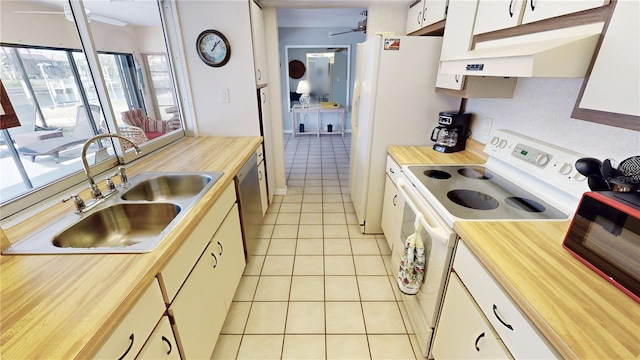 kitchen featuring a sink, electric range, dishwasher, wooden counters, and light tile patterned floors