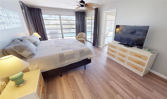 bedroom featuring light wood-type flooring, a ceiling fan, baseboards, and access to outside