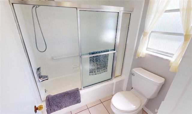 full bath featuring tile patterned flooring, toilet, and bath / shower combo with glass door