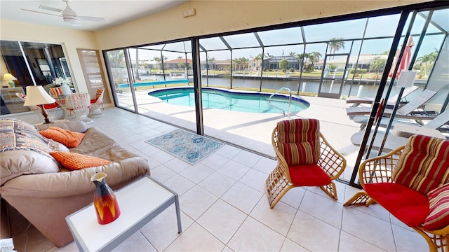 outdoor pool featuring a water view and a ceiling fan