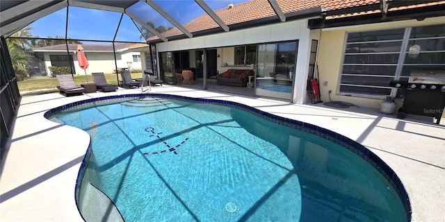 outdoor pool with a lanai and a patio area