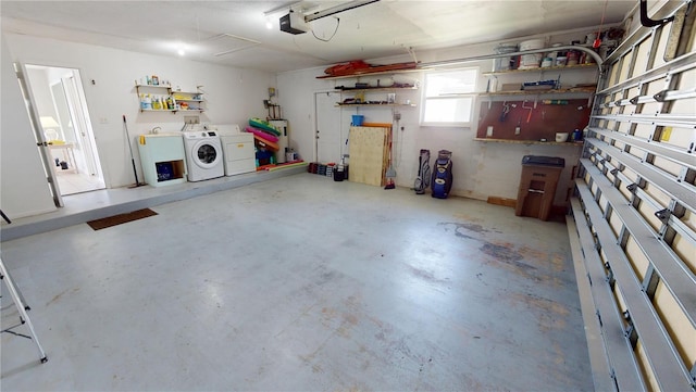 garage with independent washer and dryer and a garage door opener