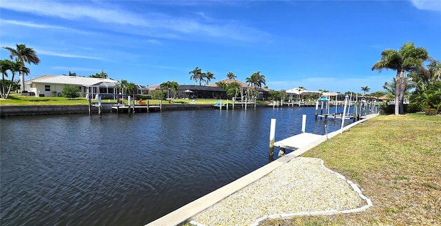 view of dock featuring a yard, boat lift, a water view, and a residential view