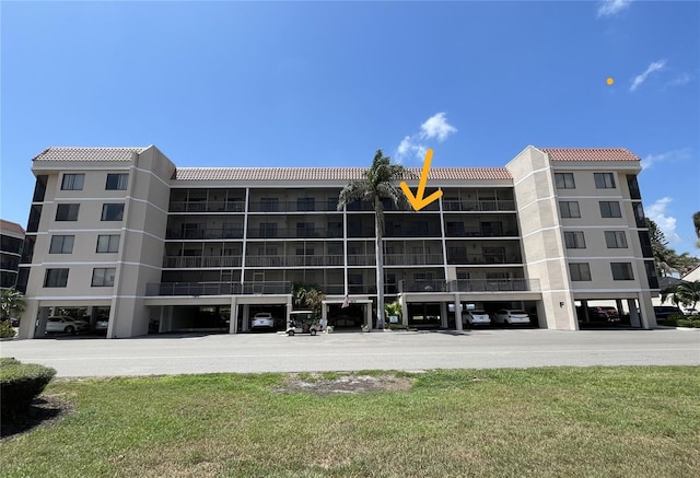 25188 Marion Ave Unit F304, Punta Gorda, FL 33950 - view of property featuring covered parking