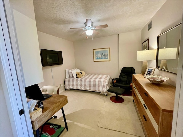 25188 Marion Ave Unit F304, Punta Gorda, FL 33950 - bedroom featuring a textured ceiling, carpet flooring, and a ceiling fan