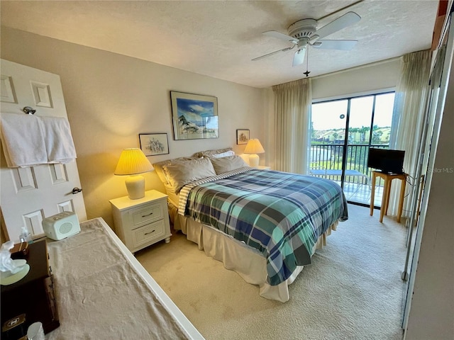 25188 Marion Ave Unit F304, Punta Gorda, FL 33950 - bedroom featuring a textured ceiling, a ceiling fan, access to outside, and light carpet