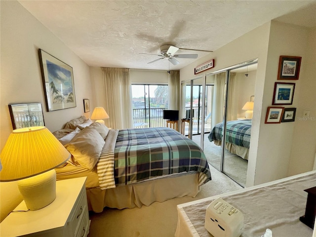 25188 Marion Ave Unit F304, Punta Gorda, FL 33950 - carpeted bedroom with a textured ceiling, ceiling fan, and access to exterior
