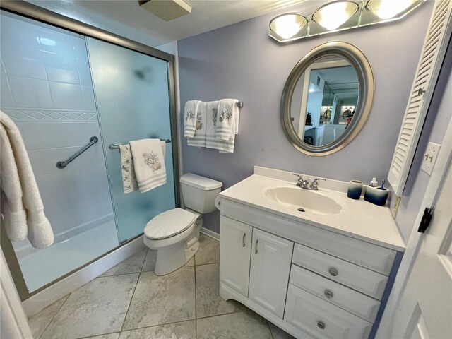 25188 Marion Ave Unit F304, Punta Gorda, FL 33950 - bathroom with a stall shower, baseboards, toilet, tile patterned floors, and vanity
