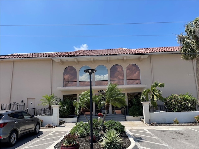 25188 Marion Ave Unit F304, Punta Gorda, FL 33950 - view of building exterior with fence and uncovered parking