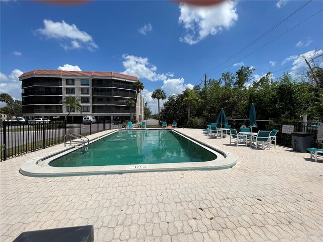 25188 Marion Ave Unit F304, Punta Gorda, FL 33950 - community pool with fence and a patio area