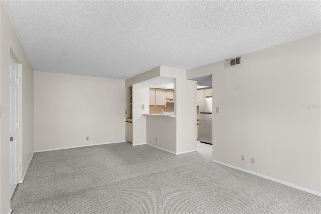 19505 Quesada Ave Unit A204, Port Charlotte, FL 33948 - empty room with a textured ceiling, visible vents, baseboards, and light carpet